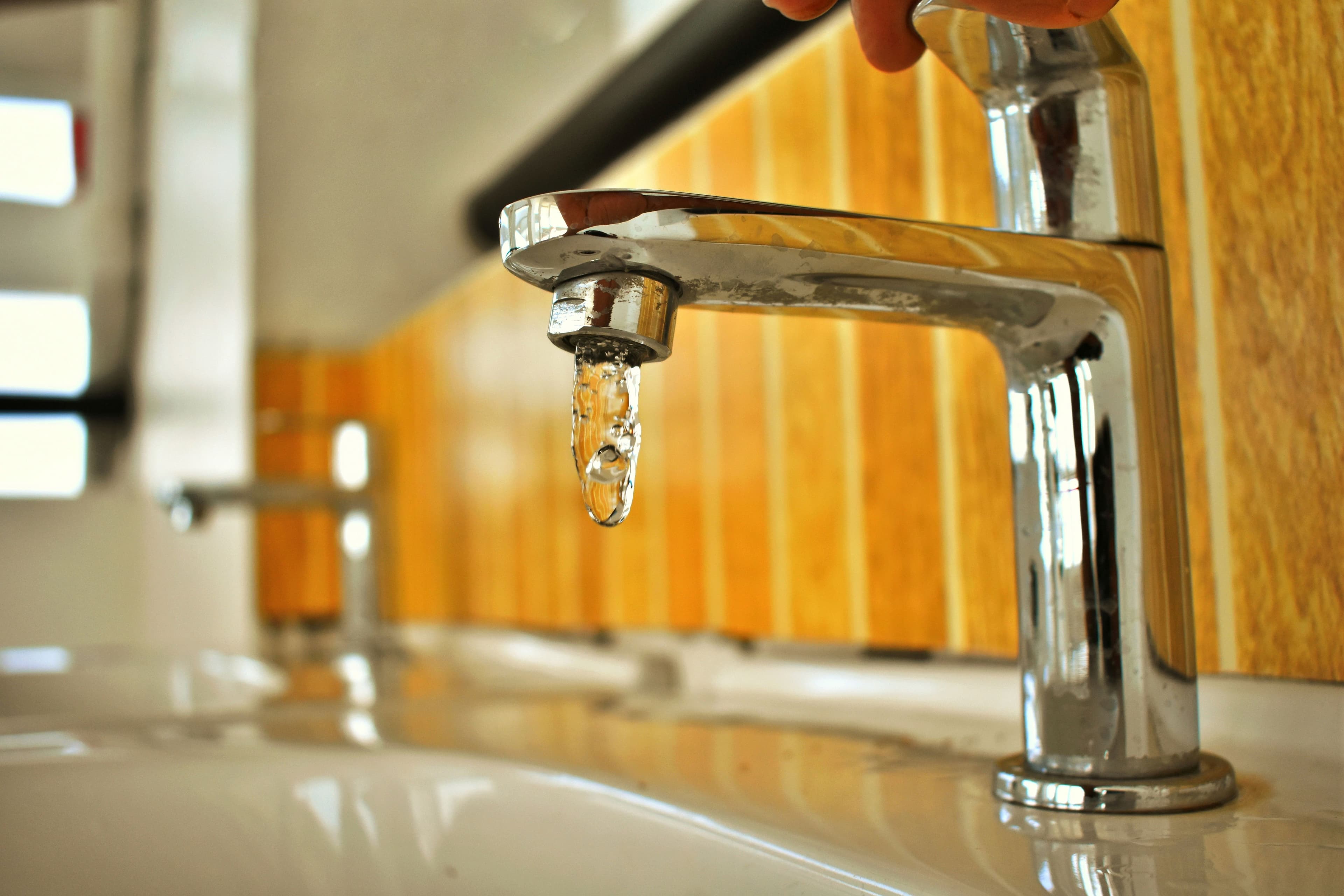 Close-up of a tap being serviced by a RapidFlow plumber